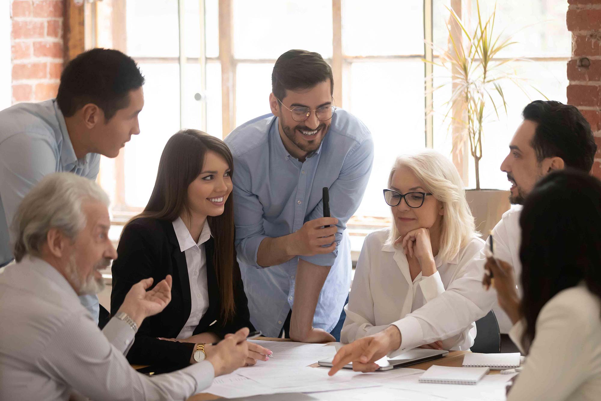 A group of employees collaborating together in an office.