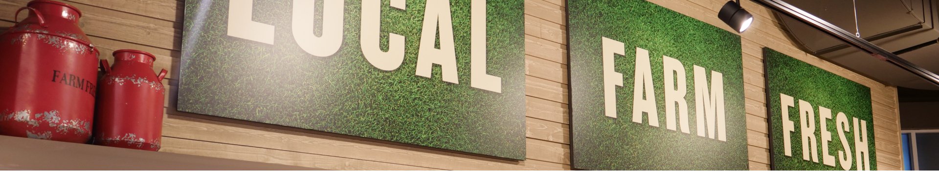 In this image, three green frames are hanging on the wall.